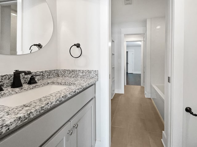 bathroom with tile patterned floors, vanity, and shower / bathtub combination