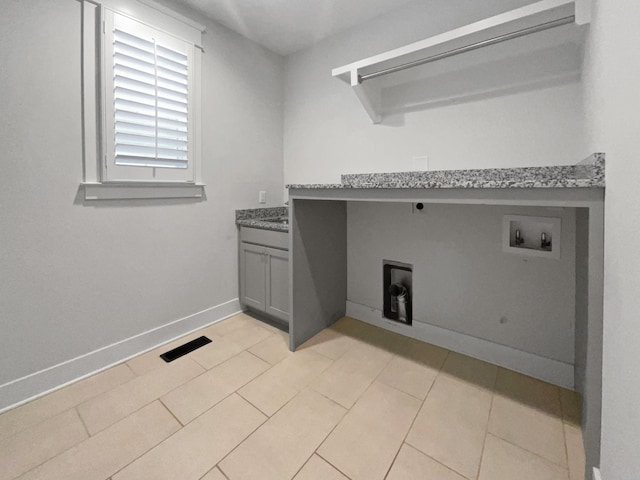 washroom featuring cabinets, hookup for a washing machine, and hookup for an electric dryer