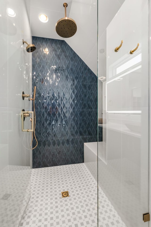 bathroom with a shower with door