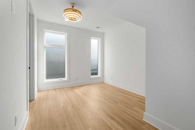 spare room with light hardwood / wood-style floors