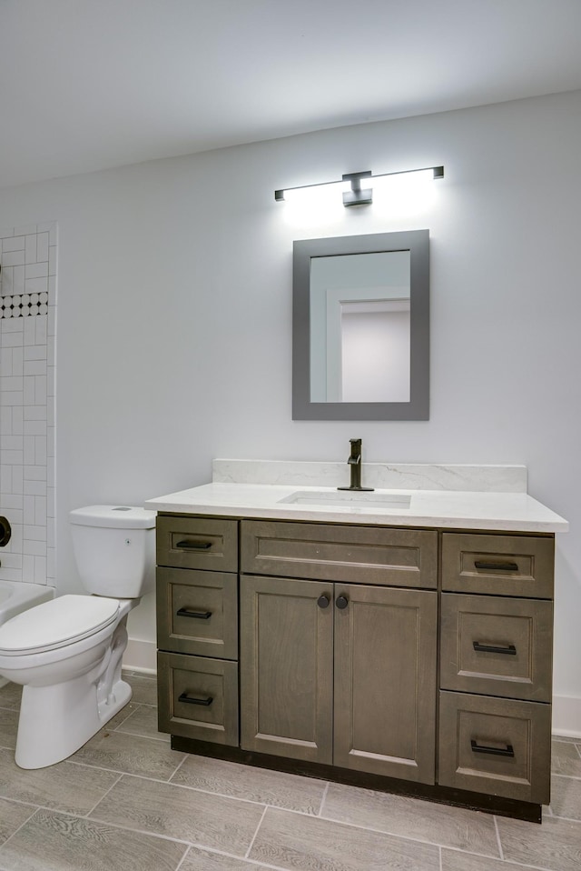 full bathroom with vanity, tiled shower / bath, and toilet