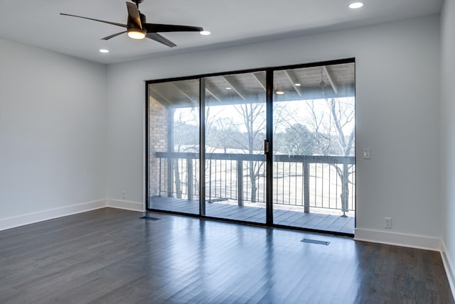 empty room with ceiling fan and dark hardwood / wood-style flooring