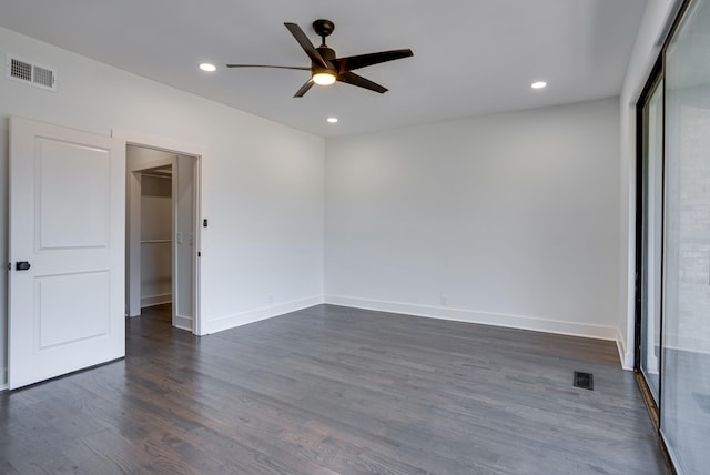 unfurnished bedroom with dark hardwood / wood-style floors, a closet, and ceiling fan