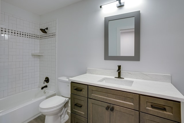 full bathroom featuring vanity, toilet, and tiled shower / bath combo