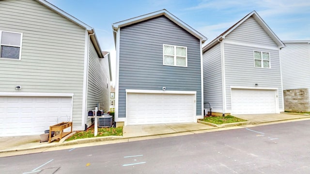 view of front of home featuring a garage and central AC unit