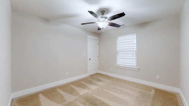 carpeted empty room featuring ceiling fan