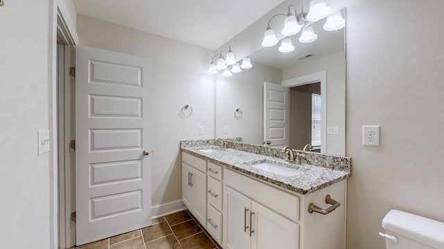 bathroom featuring vanity, tile patterned floors, and toilet