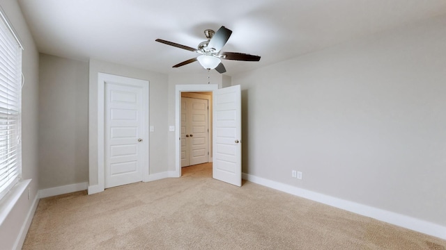 unfurnished bedroom with light carpet and ceiling fan