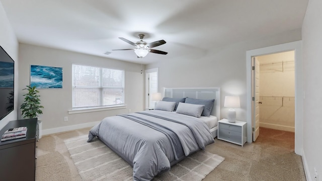 bedroom featuring light carpet and ceiling fan