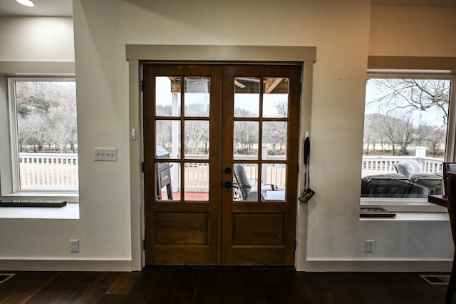 entryway with dark hardwood / wood-style floors and french doors