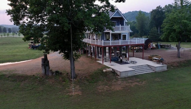 183 Big Buffalo Estates Cir, Linden, TN 37096 - back house at dusk with a balcony, a yard, and a patio