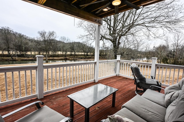 wooden terrace featuring a water view and ceiling fan