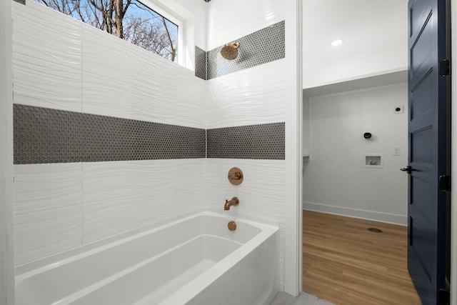 bathroom featuring wood-type flooring and shower / bath combination