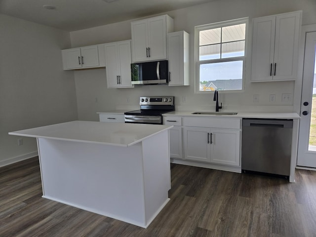 2391 Nelson Way, Cookeville, TN 38506 - kitchen featuring appliances with stainless steel finishes, a sink, dark wood-style flooring, white cabinets, and a center island