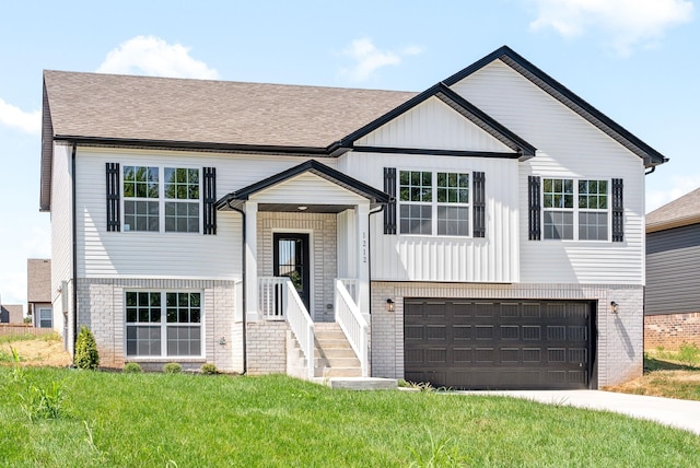 raised ranch featuring a garage and a front yard