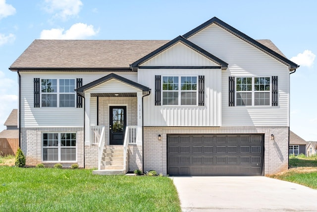 bi-level home featuring a garage and a front yard