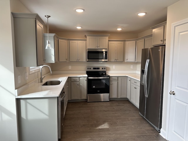 kitchen with stainless steel appliances, sink, pendant lighting, and gray cabinets