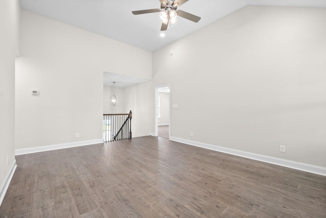 spare room with ceiling fan, dark hardwood / wood-style floors, and high vaulted ceiling