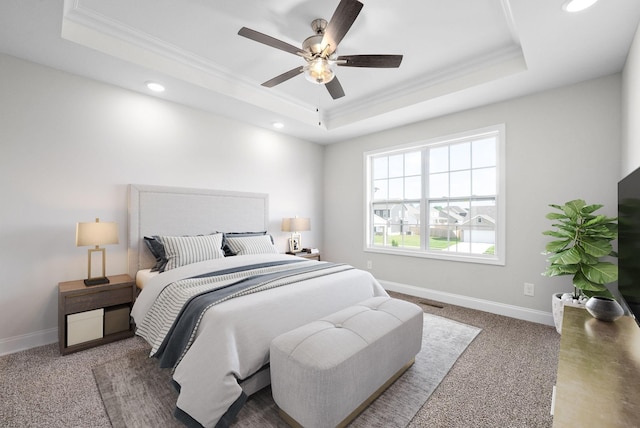 carpeted bedroom featuring crown molding, a tray ceiling, and ceiling fan