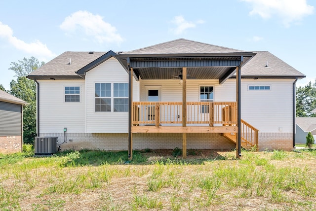 rear view of property with a wooden deck and central air condition unit