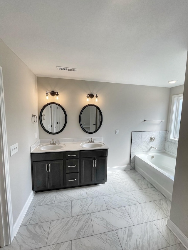 bathroom with vanity and a tub