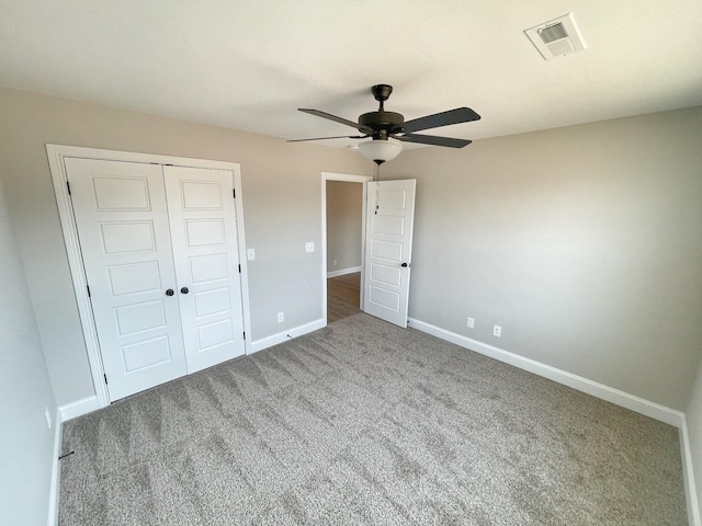 unfurnished bedroom featuring a closet, ceiling fan, and carpet