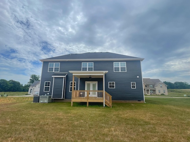 rear view of property with a yard, central air condition unit, and french doors