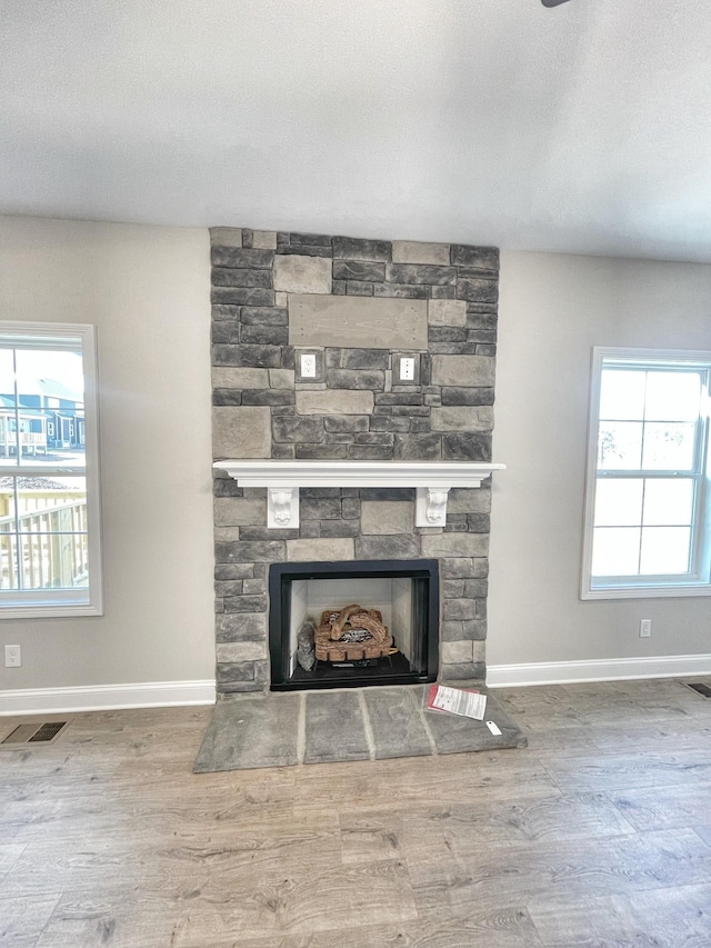 room details with wood-type flooring, a fireplace, and a textured ceiling