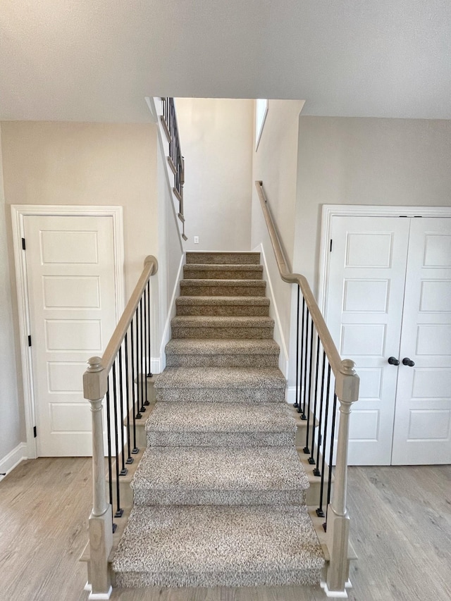 stairs with wood-type flooring