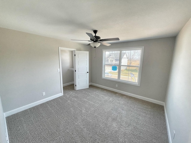 unfurnished bedroom with ceiling fan and carpet flooring