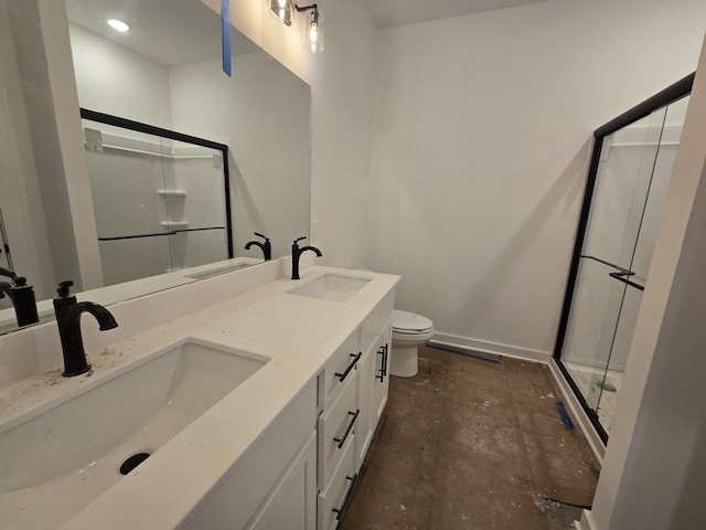 bathroom featuring a shower with door, vanity, and toilet