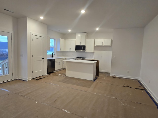 kitchen with sink, dishwasher, stove, white cabinets, and a kitchen island