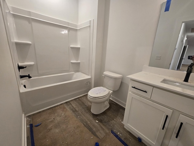 full bathroom featuring vanity, hardwood / wood-style floors, shower / bathtub combination, and toilet