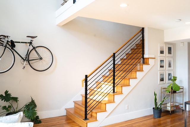 staircase with hardwood / wood-style floors