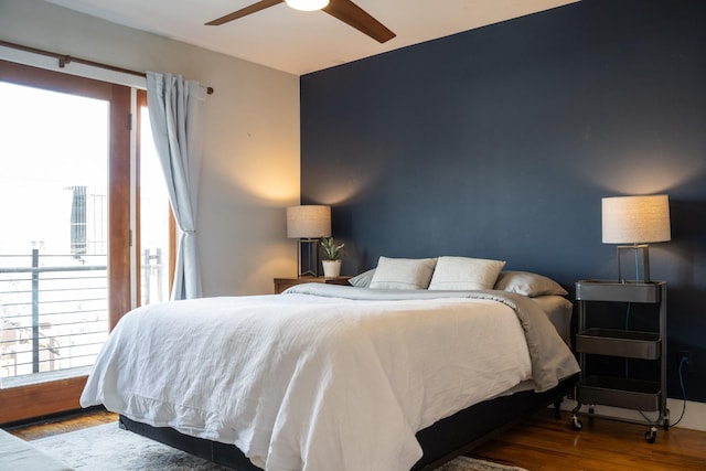 bedroom featuring access to outside, ceiling fan, and wood finished floors