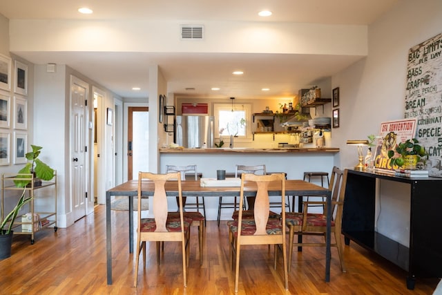 dining room with wood-type flooring