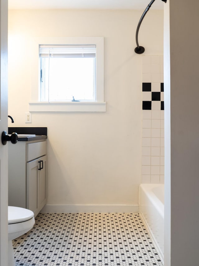 bathroom with tile patterned flooring, toilet, vanity, and baseboards