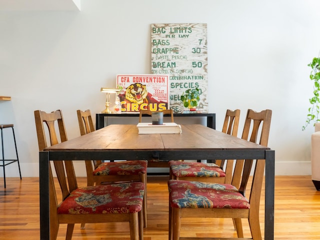 dining area with wood finished floors and baseboards