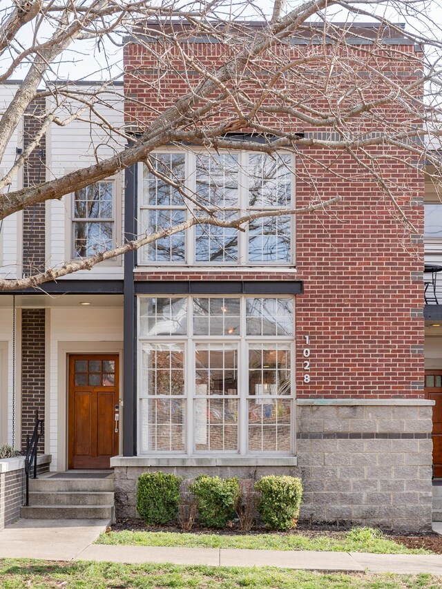 entrance to property featuring brick siding