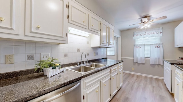 kitchen with sink, decorative backsplash, and white cabinets