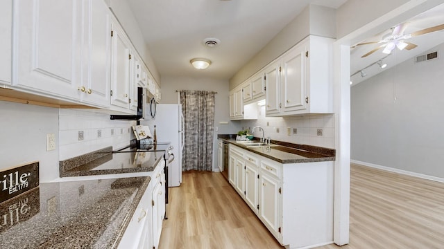 kitchen featuring dark stone countertops, sink, stainless steel appliances, and white cabinets