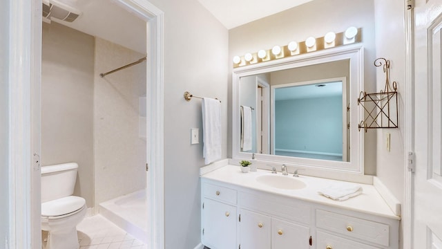 bathroom with a shower, vanity, tile patterned floors, and toilet