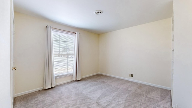 spare room with light colored carpet