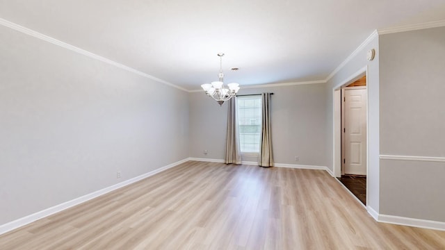 empty room featuring crown molding, light hardwood / wood-style flooring, and a notable chandelier