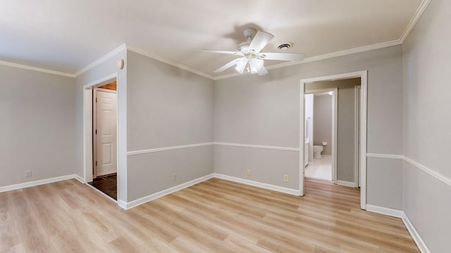 spare room featuring crown molding, ceiling fan, and light wood-type flooring