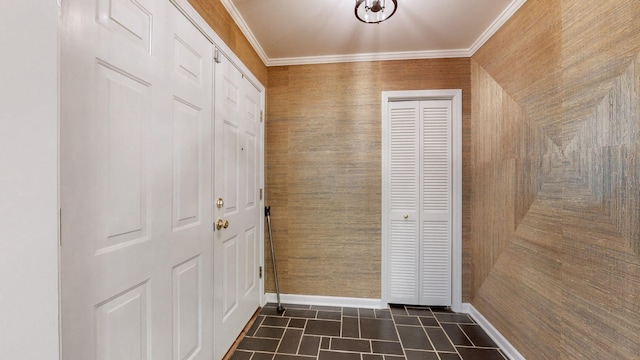 doorway to outside featuring ornamental molding and dark tile patterned floors