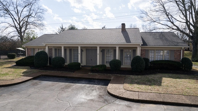 ranch-style house with a front lawn