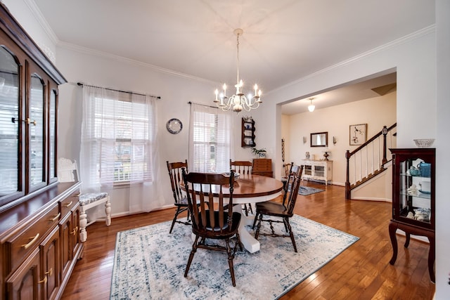 dining room with crown molding, a notable chandelier, and dark hardwood / wood-style flooring