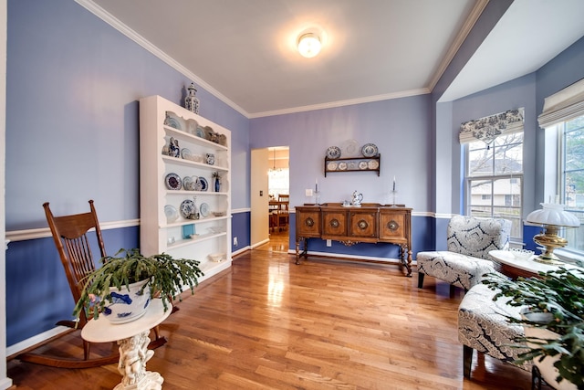 sitting room featuring ornamental molding and hardwood / wood-style floors