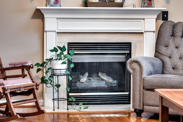 interior details featuring hardwood / wood-style flooring and a fireplace